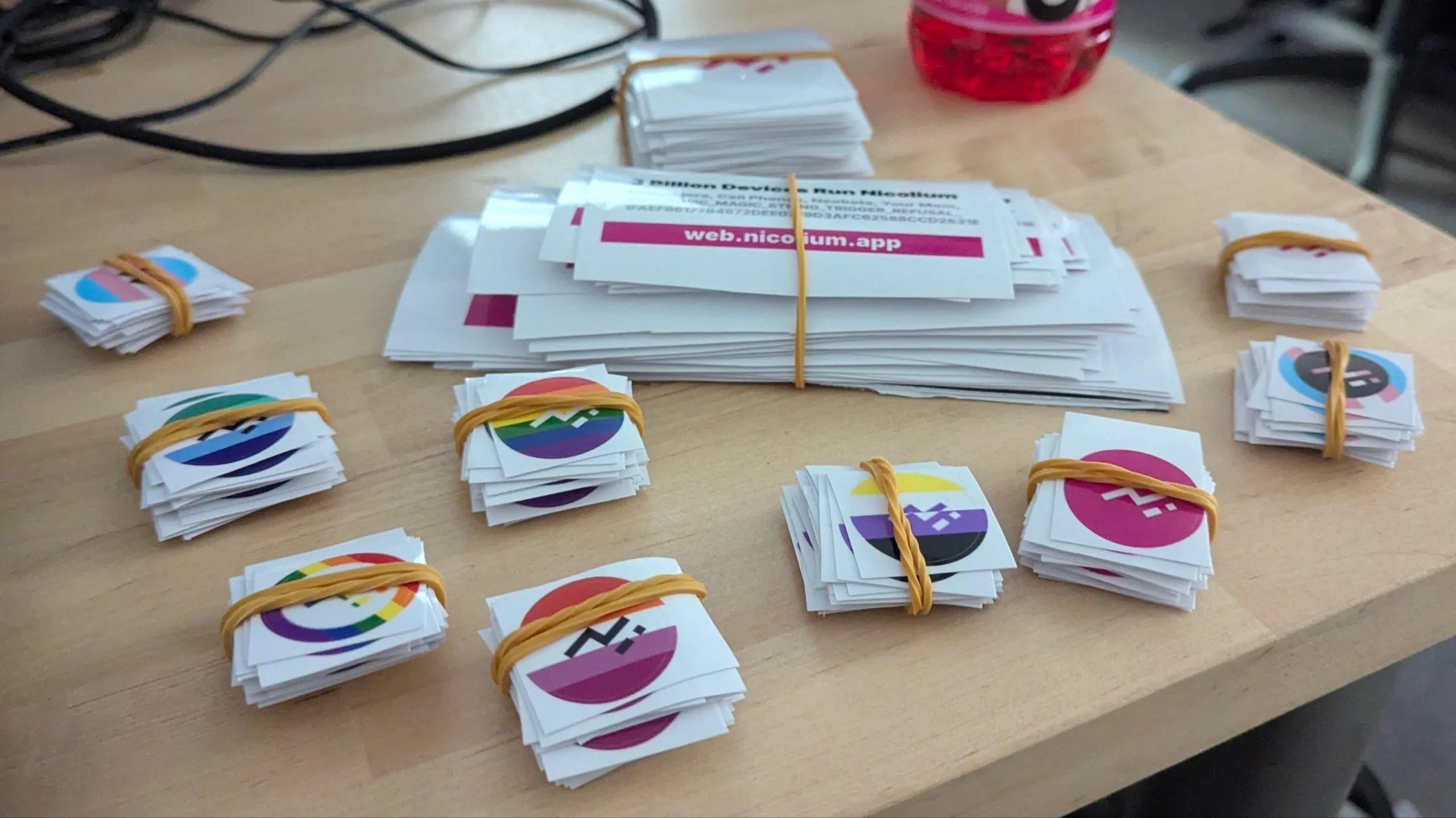 A set of Nicolium-themed stickers, mostly circle-shaped including pride flag variants and one that says '3 Billion Devices Run Nicolium'